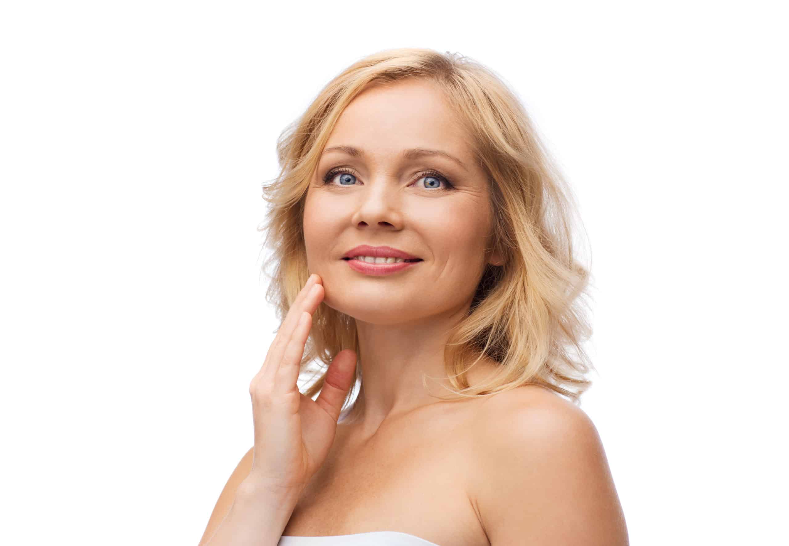smiling woman with bare shoulders touching face